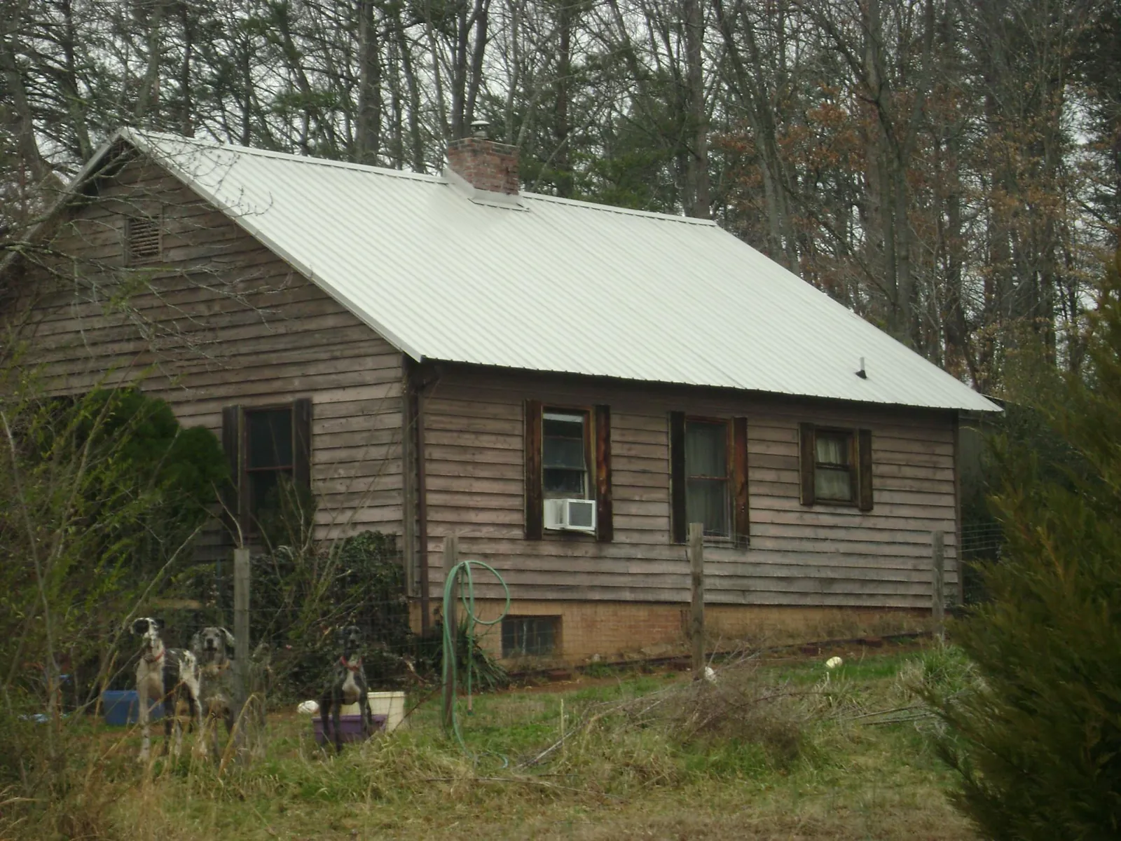 White metal roof on an old wood sided farmhouse, from a Metal Roof Installation job in Boxford